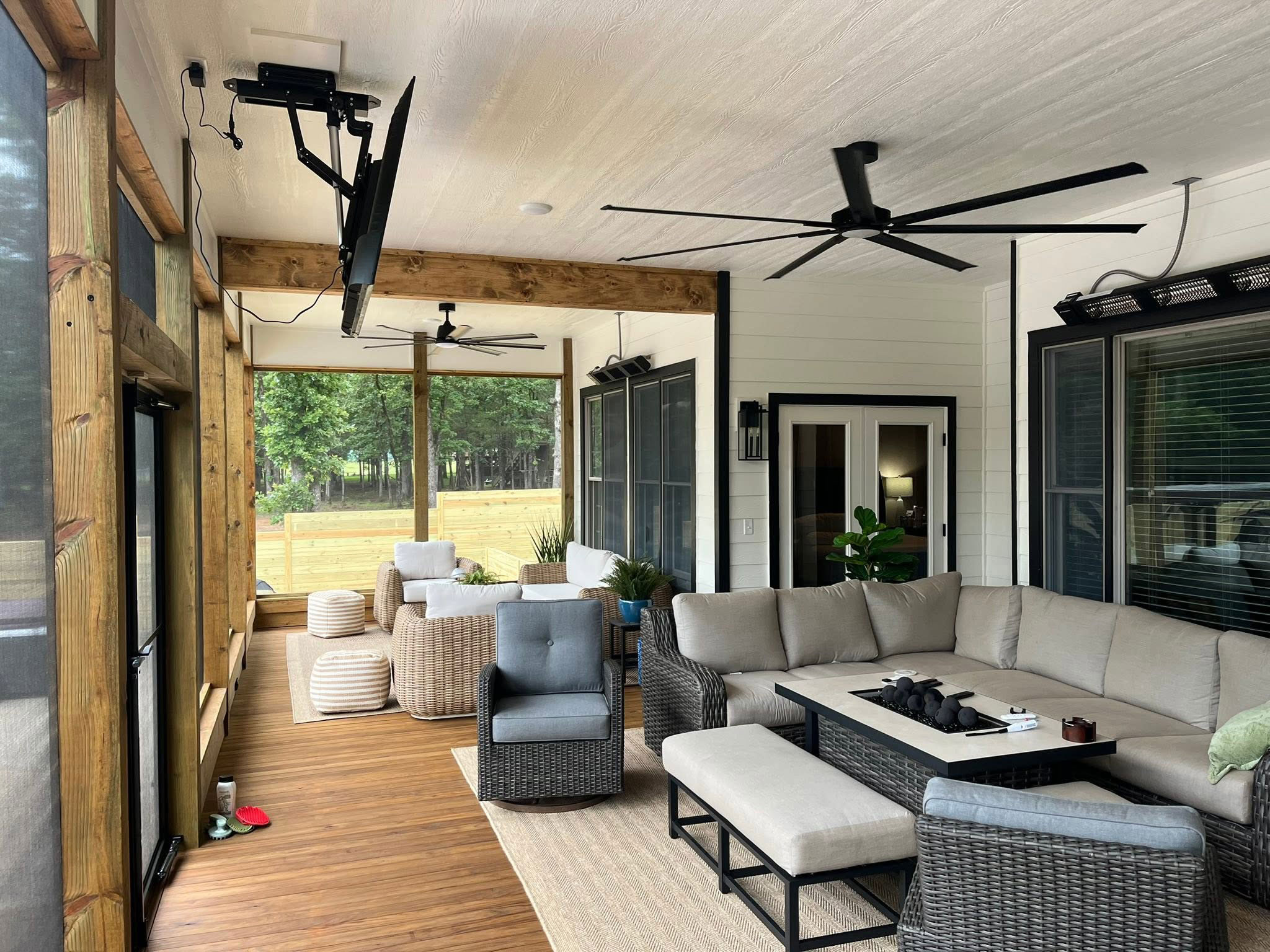 Covered outdoor porch with stone fireplace built by Mayfield Construction